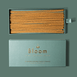 Incense sticks in a green box with 'Bloom' branding on a green background